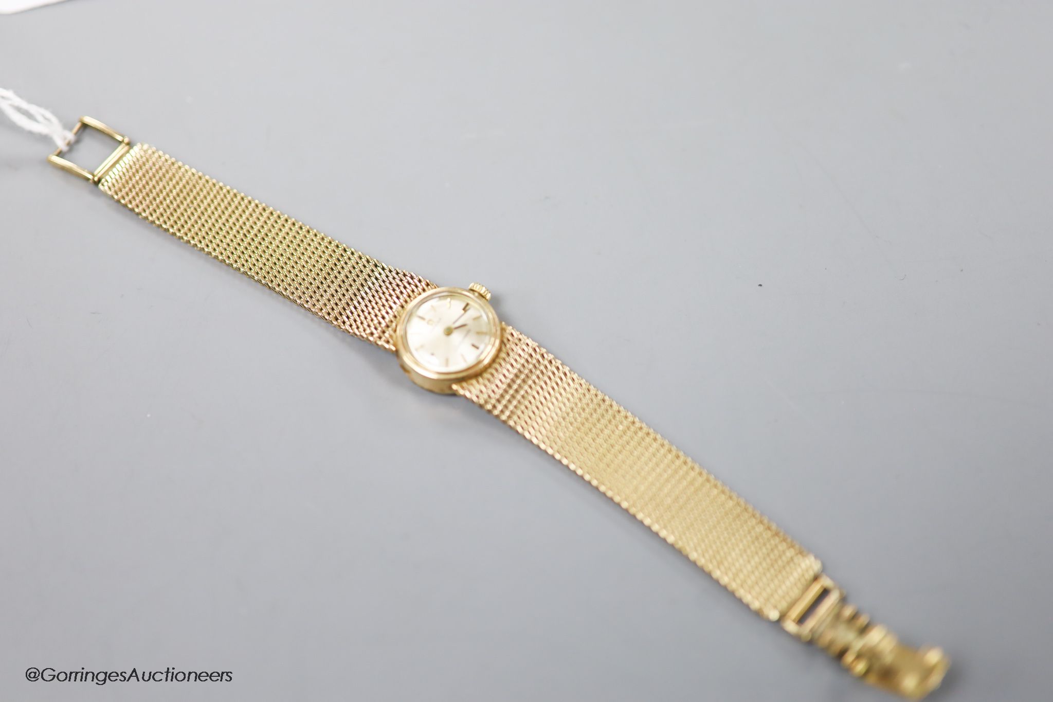 A lady's 9ct gold Omega Ladymatic wrist watch on integral 9ct gold Omega bracelet